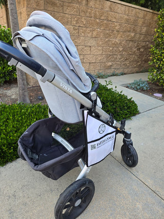 Stroller with a baby carrier attached on a sidewalk